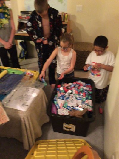 Cavanaugh kids preparing a box full of soap, art supplies, toothpaste, etc, for the Children's Home here in Honduras.  Jason and Jessica will be personally delivering it
